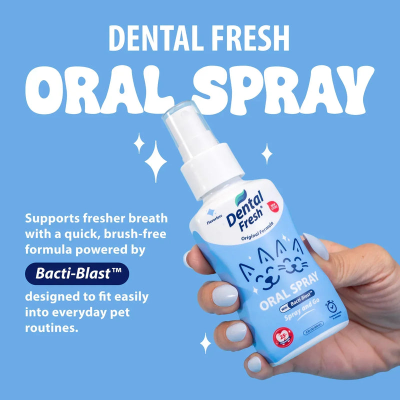 Dental Fresh Oral Spray for pets, brush-free formula with Bacti-Blast™ for fresher breath, held in hand against blue background