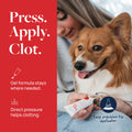 Woman applying pet wound gel with precision tip to dog's paw, promoting fast clotting and healing.