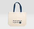 Beige tote bag with blue handles, text 'My pet asked me to grab this' and VF logo, pet-themed design